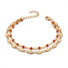 Bracelet Lerma - bracelet à maille graphique dorée et perles d’onyx rouge sur fond blanc - LELIEGE