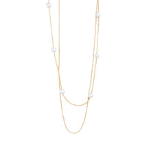 Collier Rêve Perlé - double rang chaînes à billes dorées et perles nacrées sur fond blanc - LELIEGE